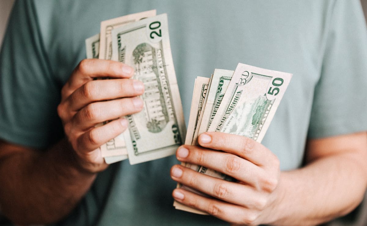 Man counting dollars after receiving benefit payment