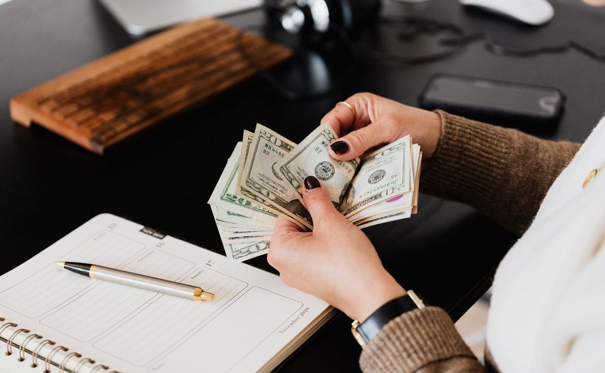 Person counting money after getting tax refund from Social Security