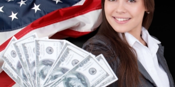 Woman holding the Tax Refund money with an American Flag