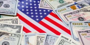 Some Social Security payments around an American Flag
