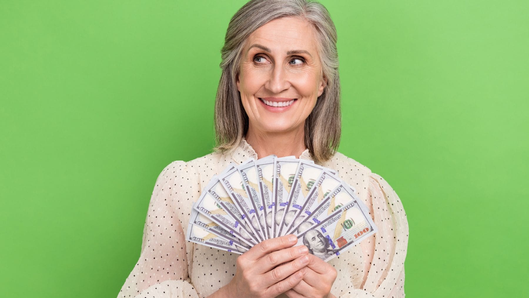A woman is holding her retirement money