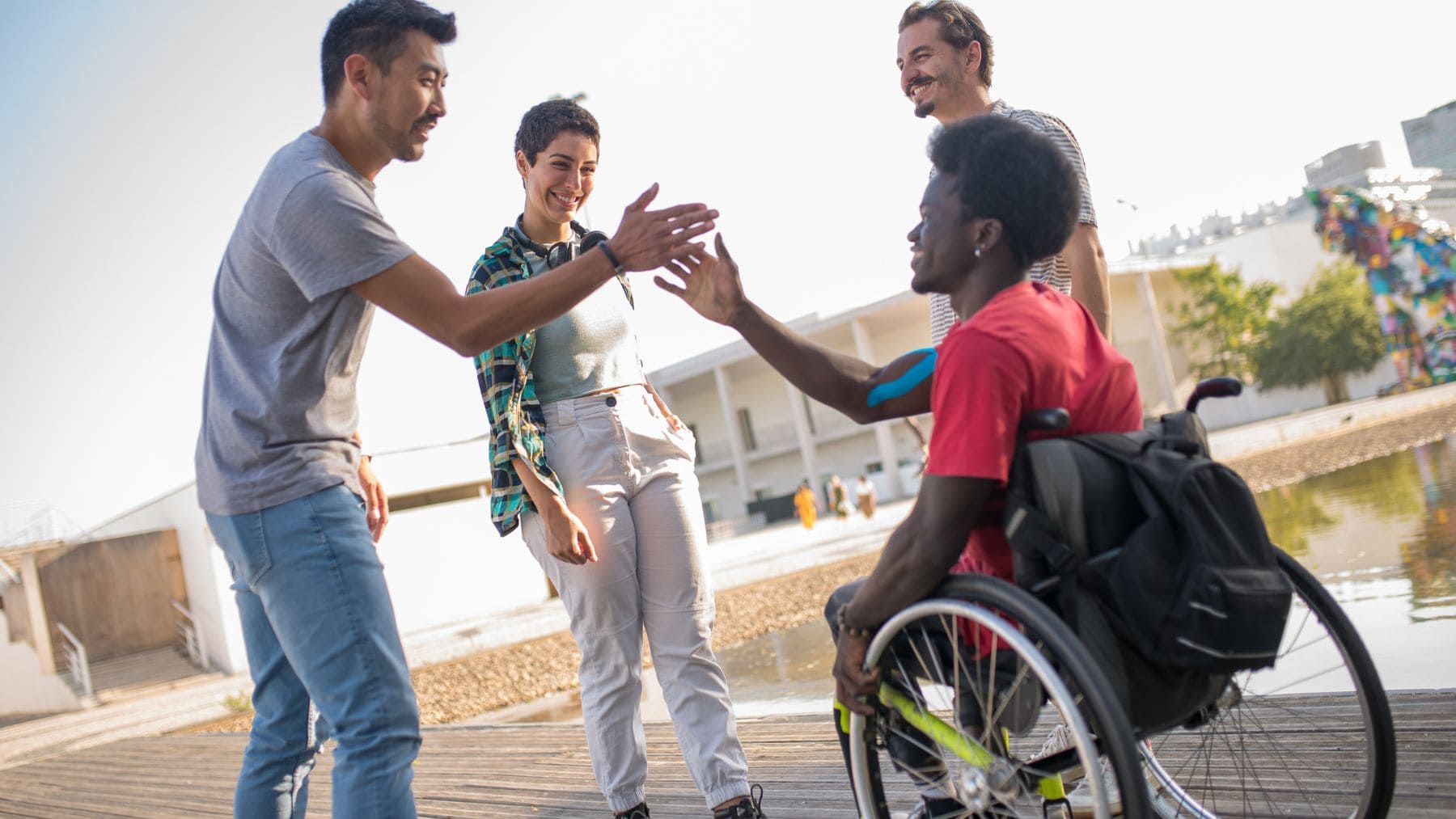 A person with a Disability is saluting a group of people