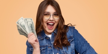 A young woman is holding her stimulus check money