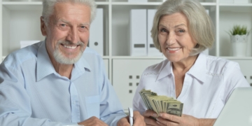 A senior couple holding their Social Security money