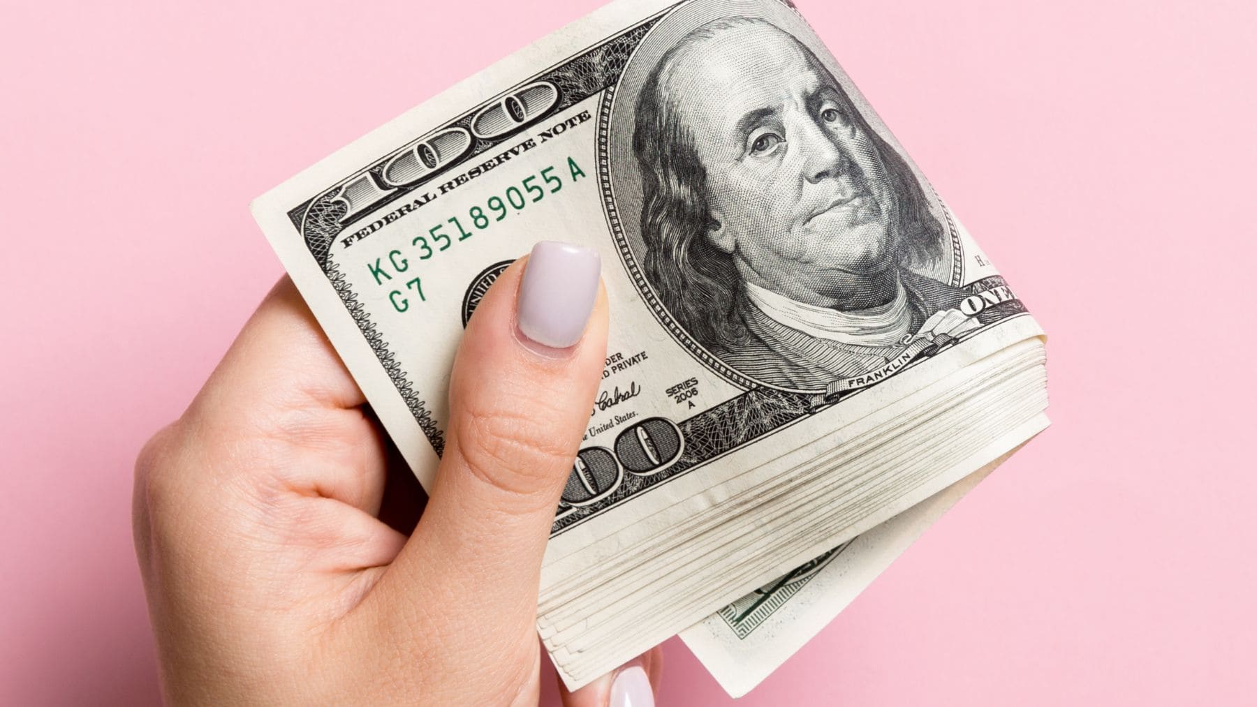 A man holding money from the Supplemental Security Income with a pink bottom