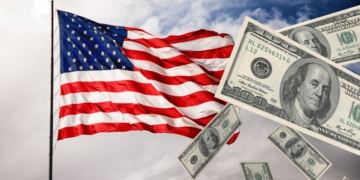 An American flag with the Stimulus check money flying