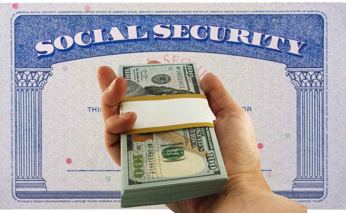 SSA card and hand with dollar wad since this will be the third Social Security payment in October 2023