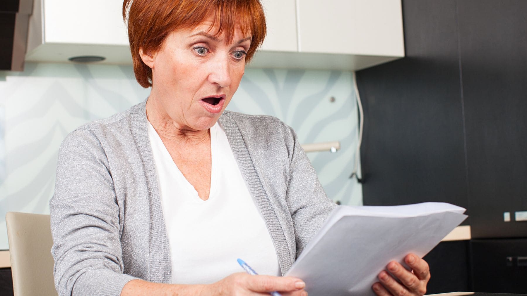 Mujer sorprendida leyendo un documento