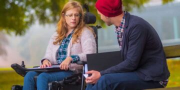 Estudiante con discapacidad junto a un compañero hablando sobre la Fundación Universa