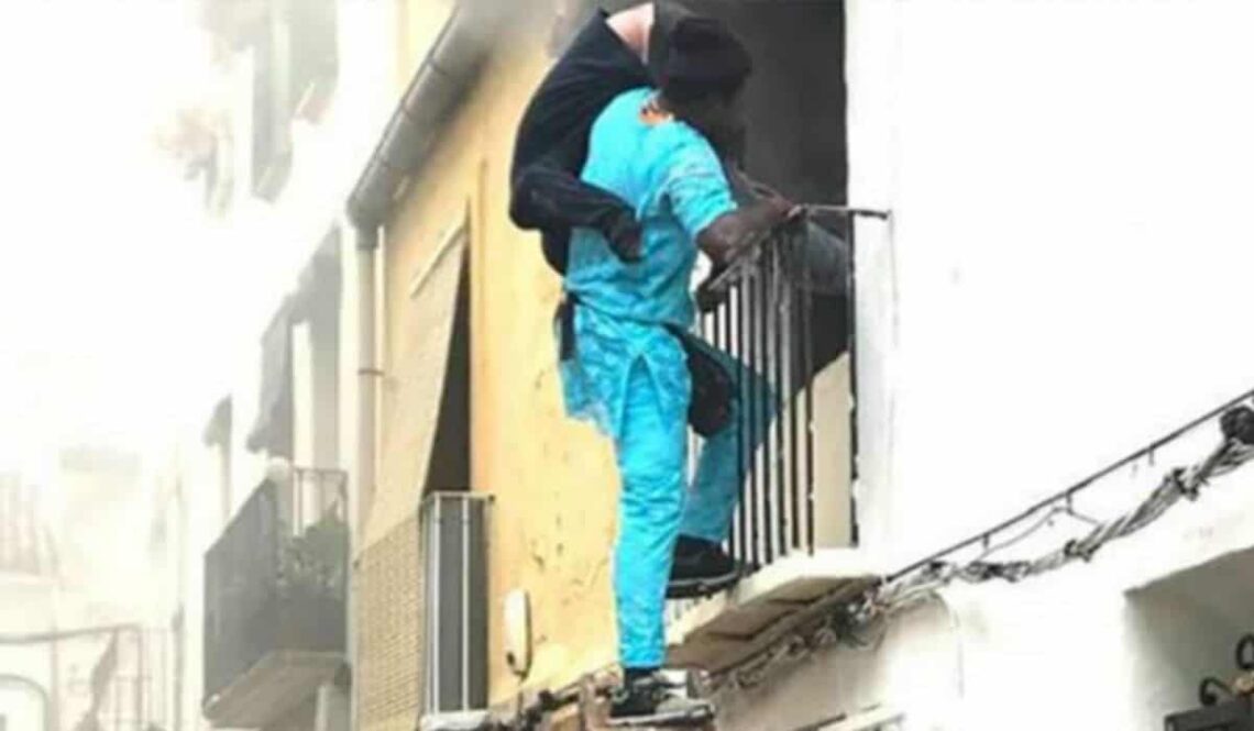 hombre rescatando a una persona con discapacidad del fuego