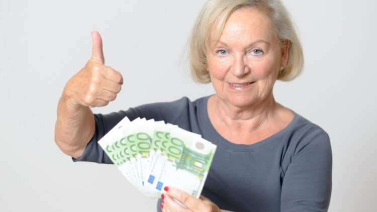 Mujer mayor con dinero en euros