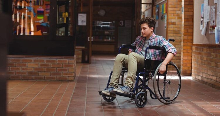 Niño con discapacidad en silla de ruedas en el colegio