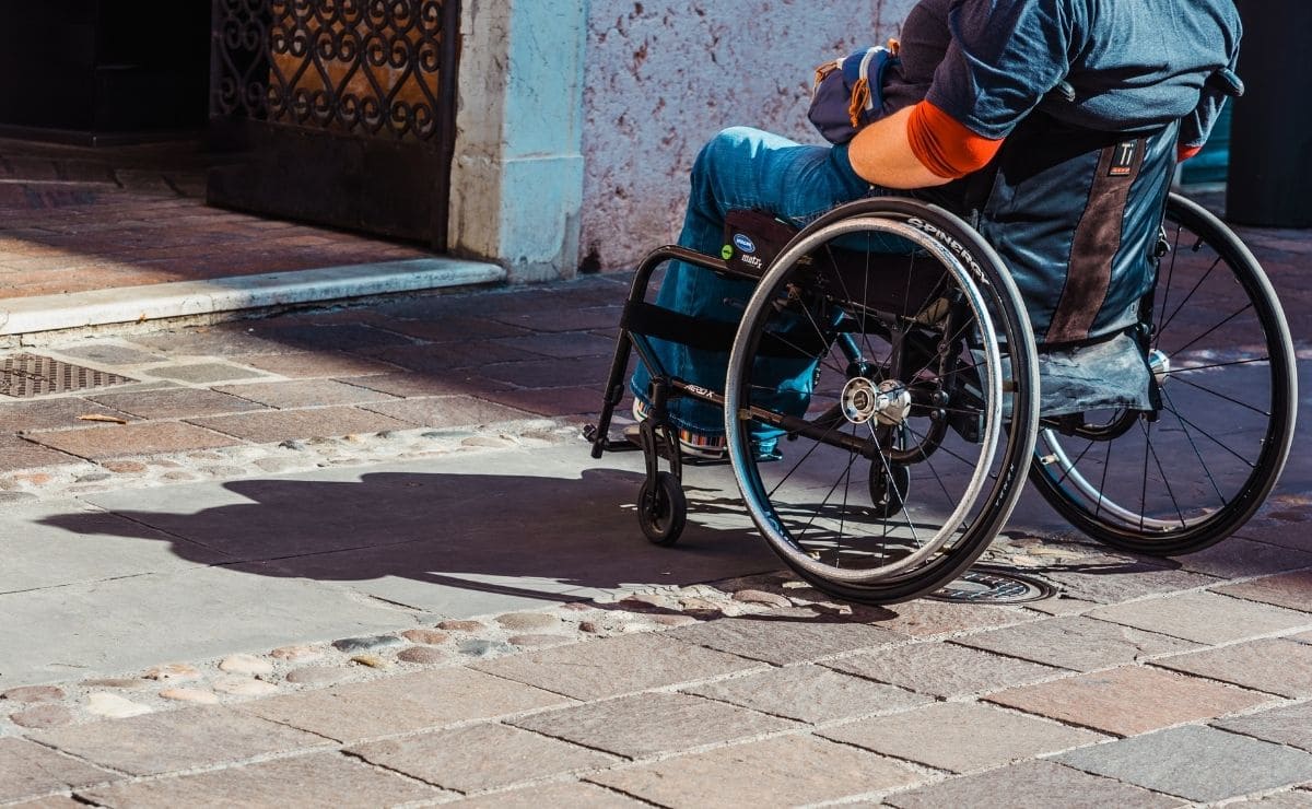 Persona en silla de ruedas en un itinerario peatonal con accesibilidad