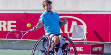 Persona jugando al tenis en silla de ruedas