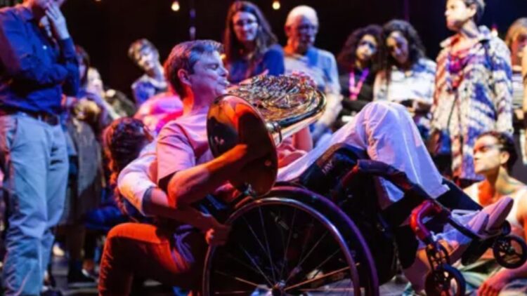 Persona usuaria en silla de ruedas de la orquesta inclusiva